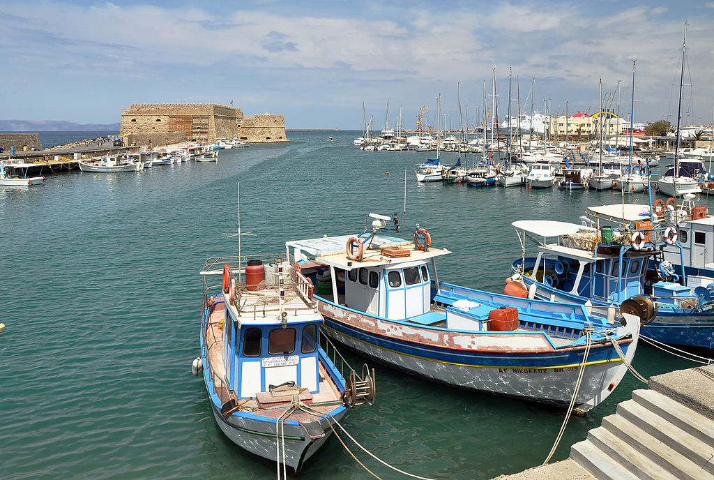 Fishing boats and marina in the old harbour of Heraklion at the north coast of Crete in Greece.